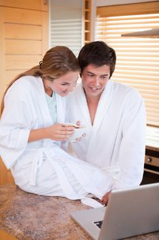 Portrait of a couple having breakfast during a video conference in their kitchen