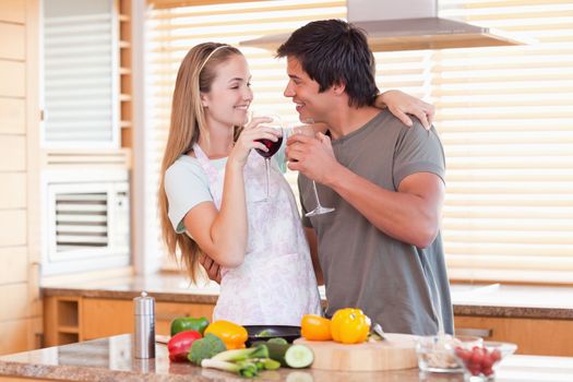 Lovely couple drinking wine in their kitchen