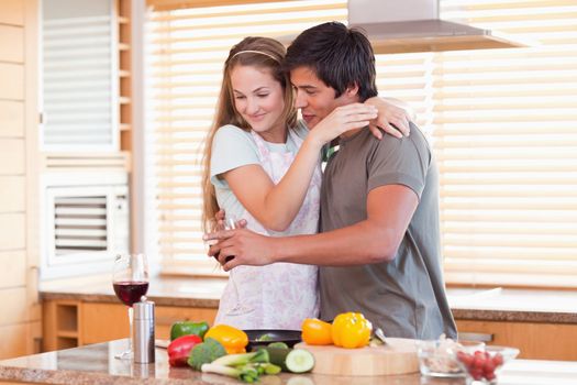 Couple drinking wine in their kitchen