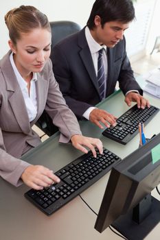 Portrait of young business people working with computers in an office