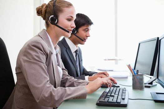 Sales assistants working with computers in an office