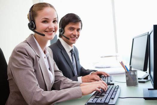 Young office workers using computers in an office