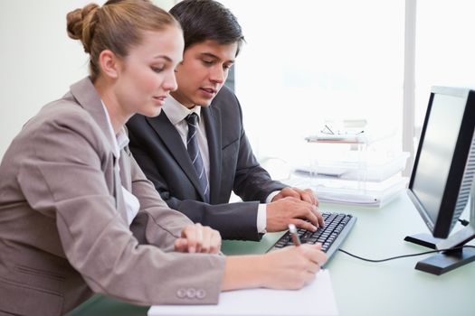 Young business people working with a computer in an office