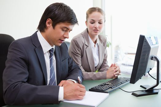 Serious business people working with a computer in an office