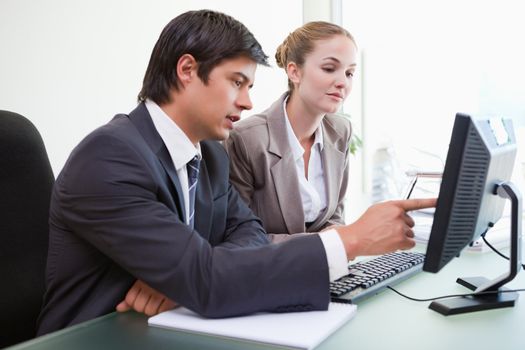 Good looking business people working with a computer in an office