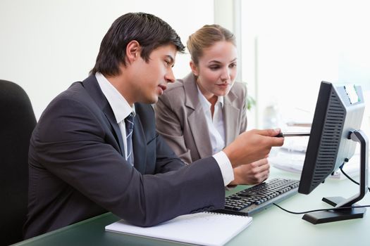 Focused business team working with a computer in an office