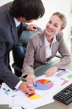 Portrait of a young business team studying statistics in a meeting room