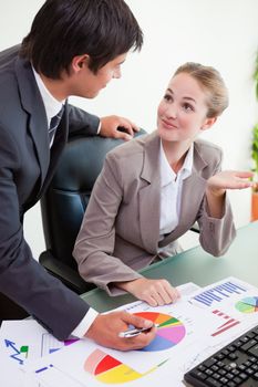 Portrait of a happy business team studying statistics in a meeting room