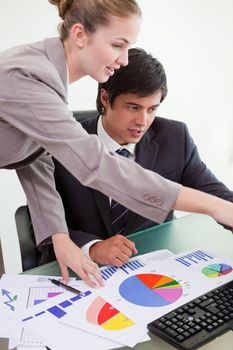 Portrait of a professional business team studying statistics in a meeting room