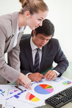Portrait of a serious business team studying statistics with a computer in a meeting room