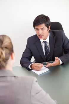 Portrait of a manager interviewing a female applicant in his office