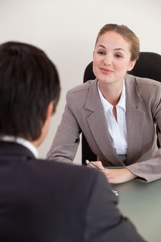 Portrait of a manager interviewing a male applicant in her office