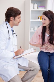 Young male doctor talking with patient