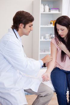 Male doctor prepares patients arm for injection