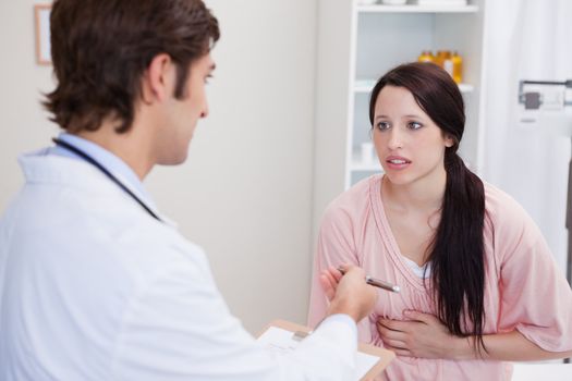 Male doctor having serious conversation with patient