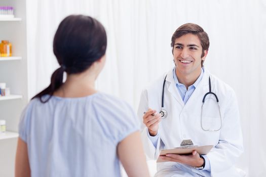 Young physician having good news for patient