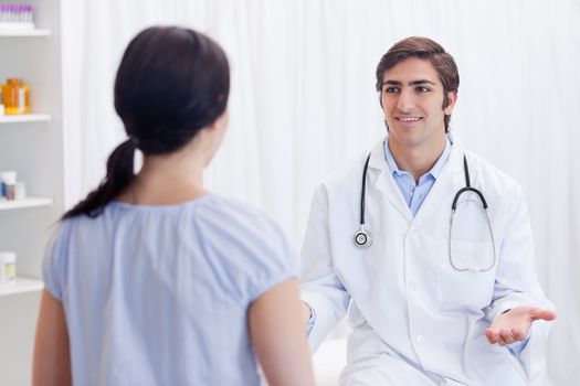 Young physician having a conversation with patient