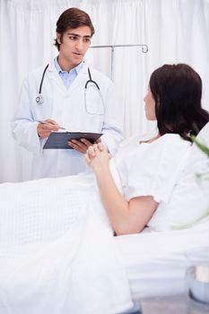 Young doctor preparing his patient for surgery