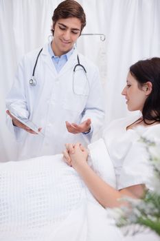 Young doctor talking with patient about examination results