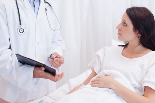 Young female patient getting examination results explained