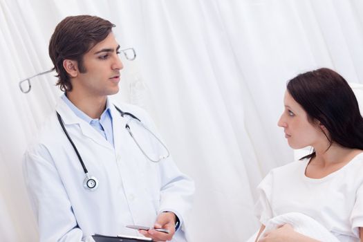 Female patient getting examination results explained by doctor