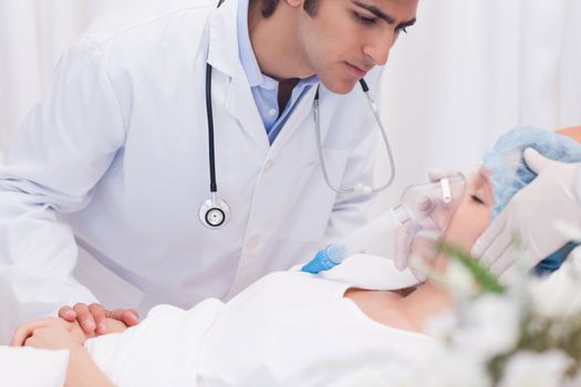 Male doctor examining intensive care patient