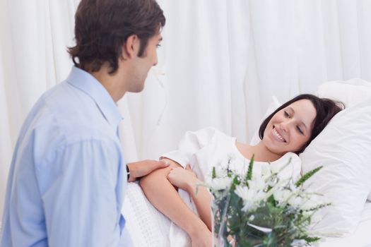 Young man visiting his girlfriend in the hospital