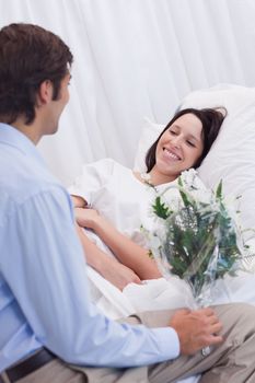 Young woman is happy about receiving a visit at the hospital