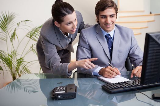 Young businessman explaining her colleague what he has to do