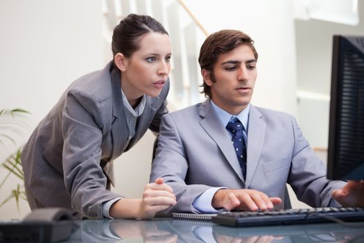 Young business team looking at computer screen together