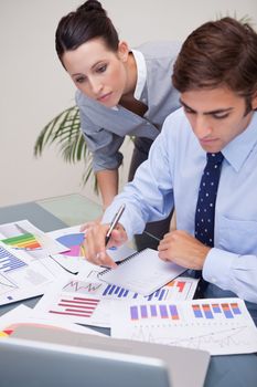Young business team analyzing statistics together