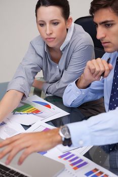 Young business team analyzing charts together