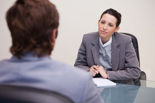 Young businesswoman listening to her business partner