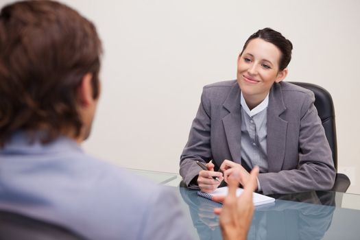 Smiling young businesswoman in a meeting