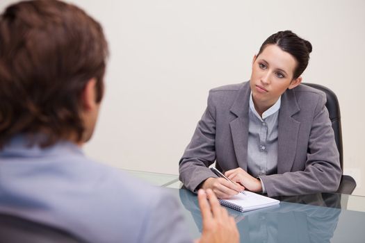 Young businesswoman taking notes in a meeting