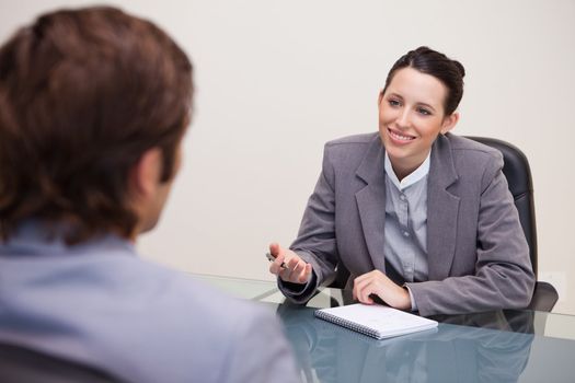 Smiling young businesswoman in a negotiation