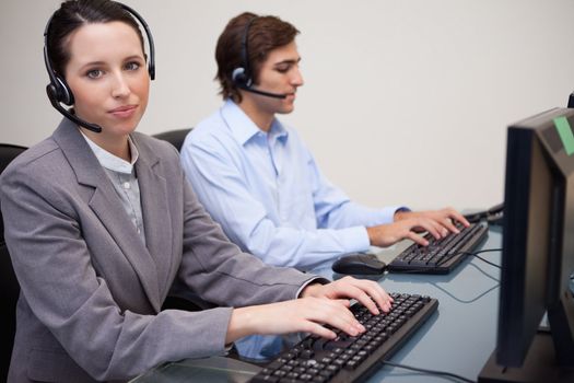 Side view of working young call center agents