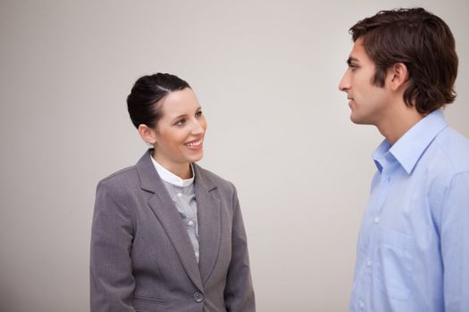 Young businesswoman smiling at her colleague