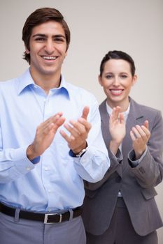 Standing young business team clapping