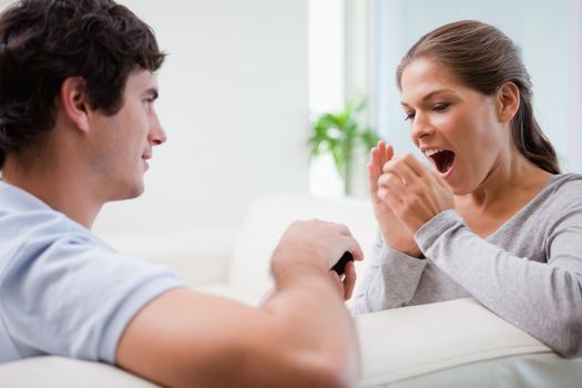 Young man surprising his girlfriend with a proposal