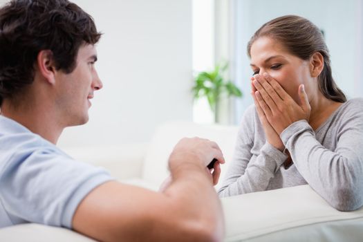 Young man making his girlfriend speechless with proposal