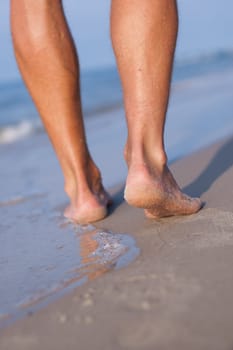 Closeup of man's feet at the shore