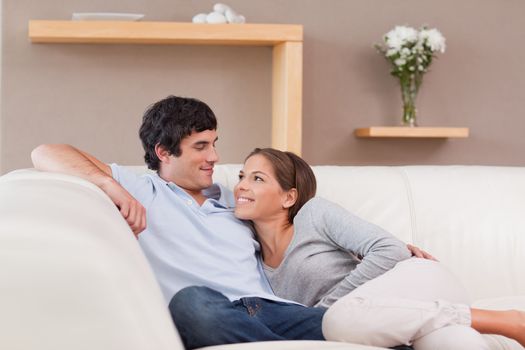 Young couple on the sofa in love