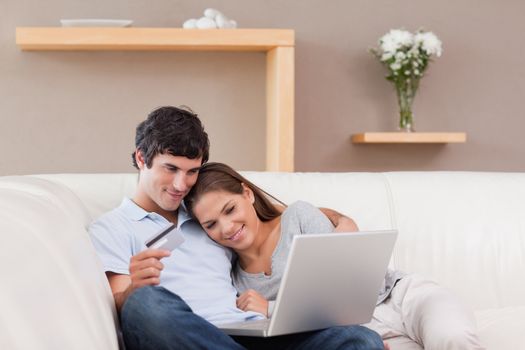 Happy young couple booking holiday online