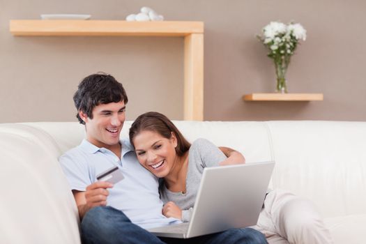 Young couple on the sofa shopping online
