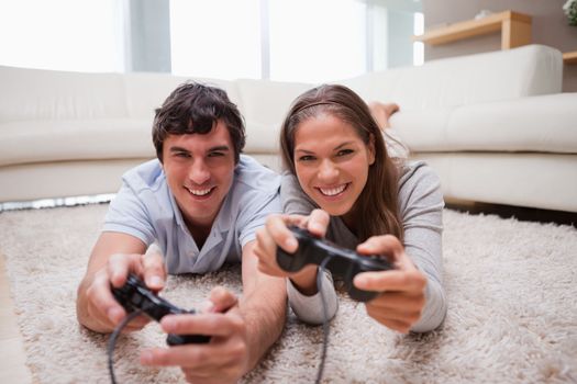 Young couple playing video games in the living room