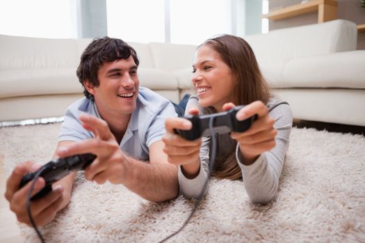Happy young couple playing video games together