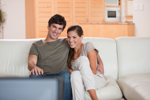 Young couple on the sofa watching a movie together