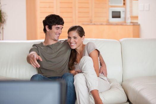 Young couple on the sofa enjoying a movie together