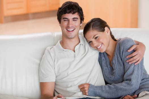 Happy young couple enjoying their time together on the sofa